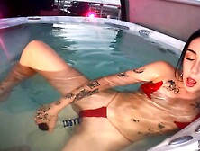 A sexy girl has sex with herself in the jacuzzi using a dildo