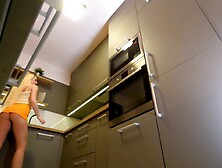 Lengthy hair lengthy legs sexy blond college cutie on high heels and a miniskirt which does not cover her butt in the kitchen