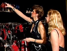 Two masked latex chicks jerk off his hard cock