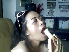 THAI OLDER LADY SHOWING HER LARGE LOVE BUBBLES AND ENGULFING BANANA