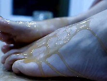 Naughty Girl Is Pouring Honey All Over Her Lovely Feet And Toes