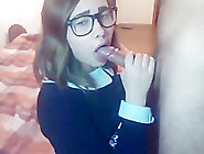 Beautiful college girl with glasses gives a blowjob