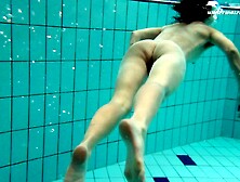 Saucy cutie jumps into the water and takes off her bikini