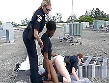 Milf Cops Chase Peeping Tom Up To A Rooftop And Subdue Him Into Drilling Them