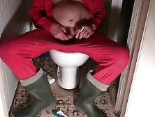 Nlboots - Red Union Suit & Green Boots On Toilet