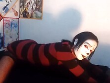 Gothic femboy in constricted costume and underware shows off her butt