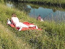 Nudist Beach.  Public Nudity.  Naked In Public.  Sexy Milf Without Panties And Bra Sunbathes Naked Nude