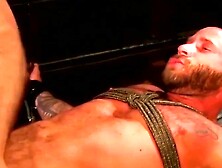 Dominatrix Pins And Whips Submissive Man In Bondage Session