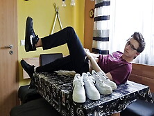 Young Boy Having Fun At The Dining Table With Sneakers