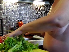 Housewife with big saggy tits crumbles salad in the kitchen.