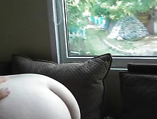 Hairy mature flashing in front of window