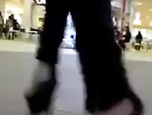 Teen Heel Flashing In Mall