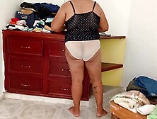 Overweight Mommy Tidying Up Room And Folding Laundry three