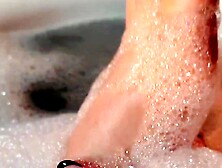Sexy golden-haired massaging her soaked soapy feet in the baths