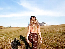 A Girl With A Beautiful Body Poses In A Field