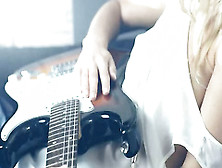 Sleek Blonde And Her Guitar