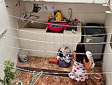 The neighbor is watched washing clothes by her neighbor