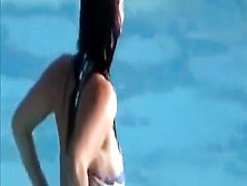 Busty girl's tit pops out while she was going down the waterslide