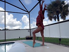 Yoga Instructor Stretching By The Pool