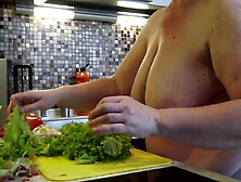 Housewife with large saggy titties crumbles salad in the kitchen.
