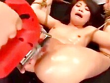 Her hands and feet are restrained and a machine vibrator is inserted and removed repeatedly.