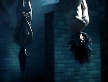 Two Asian Ladies Are Naked While Tied Upside Down In A Chamber.