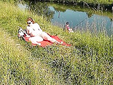 Nudist Beach.  Public Nudity.  Sexy Milf Without Panties And Bra Sunbathes Naked Is Not Shy About Fisherman.  Naked In Public.  Milf