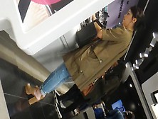 Sexy brunette in high heels and tight jeans filmed at the shopping mall