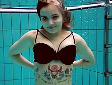 Hot inked honey strips out of her clothes inside of the pool