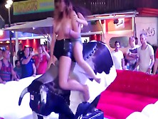 Two Sexy Chicks Jumps On An Mechanical Bull While Being Topless