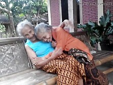 Two Very Old Grannies Giving A Kiss