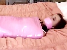 Mummified and gagged with a pink tape