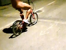 Hot chap disrobes on a public street and rides a bike nude touching his weenie - risky