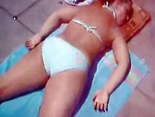 Donna Laying Out In Bikini