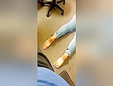 Dark Haired Woman In Blue Jeans Poses Barefoot On The Floor