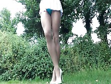 Crossdresser Removing Skirt To Swimsuit Outdoors.